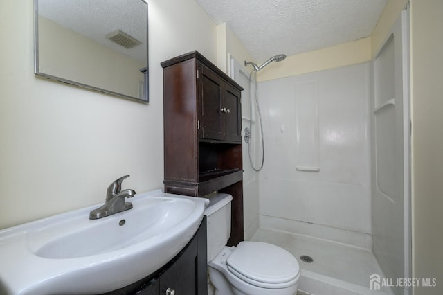 full bath with visible vents, a textured ceiling, walk in shower, and toilet
