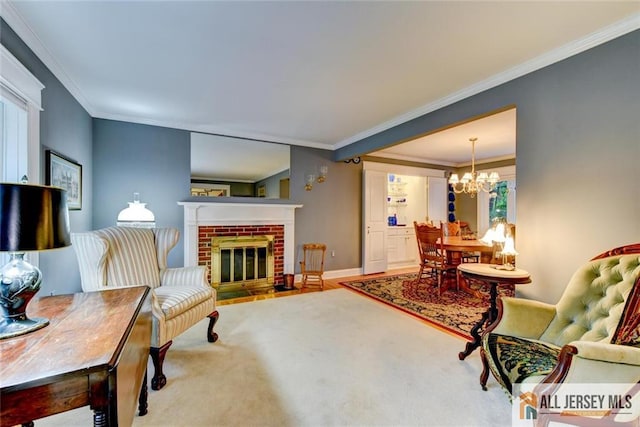 living room with a fireplace, a chandelier, hardwood / wood-style flooring, and ornamental molding