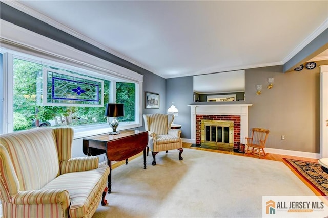 sitting room with hardwood / wood-style floors, a brick fireplace, and ornamental molding