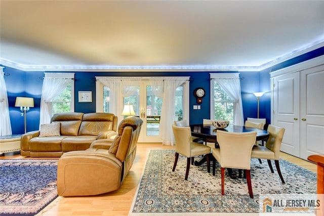 dining area featuring light hardwood / wood-style flooring and ornamental molding