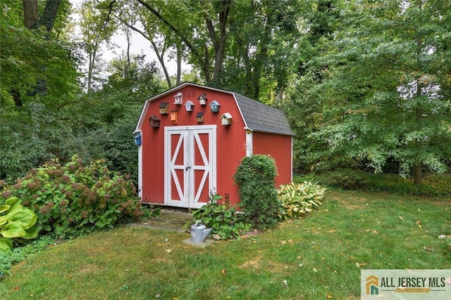 view of outbuilding featuring a lawn