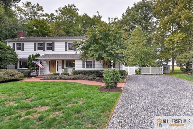 view of front of home with a porch and a front yard