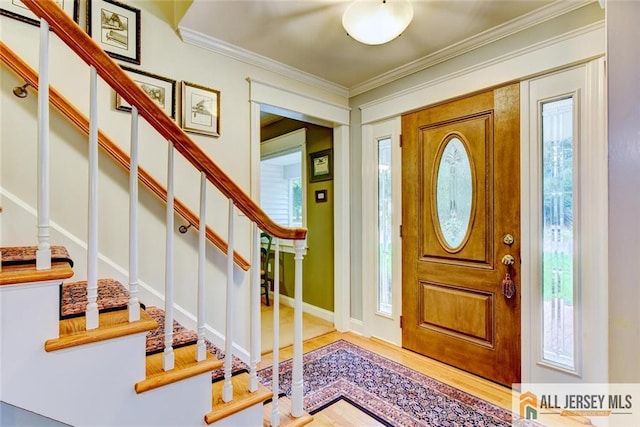 foyer featuring crown molding and hardwood / wood-style flooring