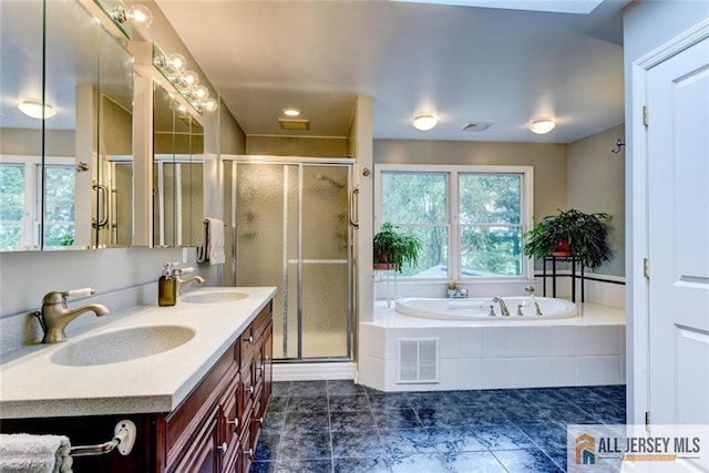 bathroom featuring vanity and shower with separate bathtub