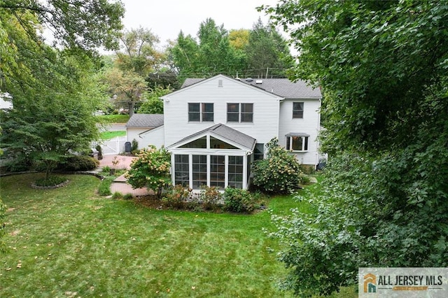 back of house with a lawn