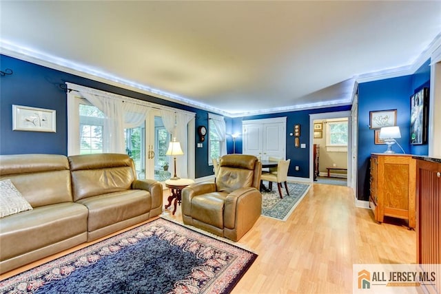 living room featuring baseboard heating, ornamental molding, and hardwood / wood-style flooring