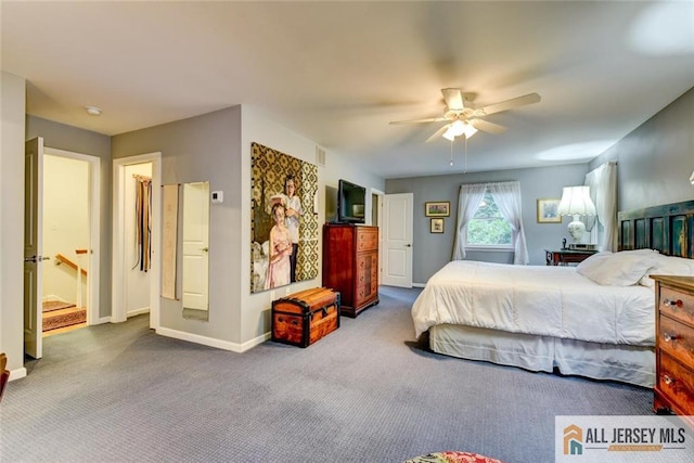 bedroom featuring carpet, ceiling fan, and ensuite bath