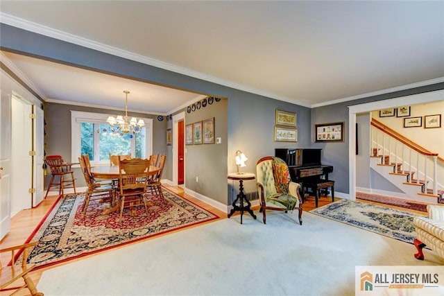 dining room with hardwood / wood-style flooring, crown molding, and a notable chandelier