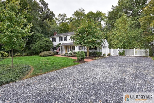 view of front of house with a porch and a front yard