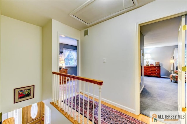 corridor with hardwood / wood-style flooring