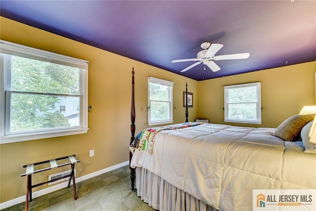 bedroom with multiple windows and ceiling fan