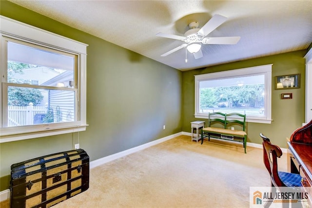 sitting room featuring ceiling fan and light colored carpet