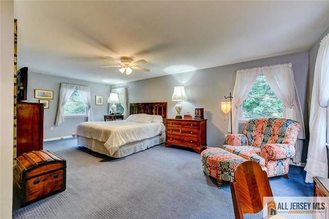 carpeted bedroom with multiple windows and ceiling fan