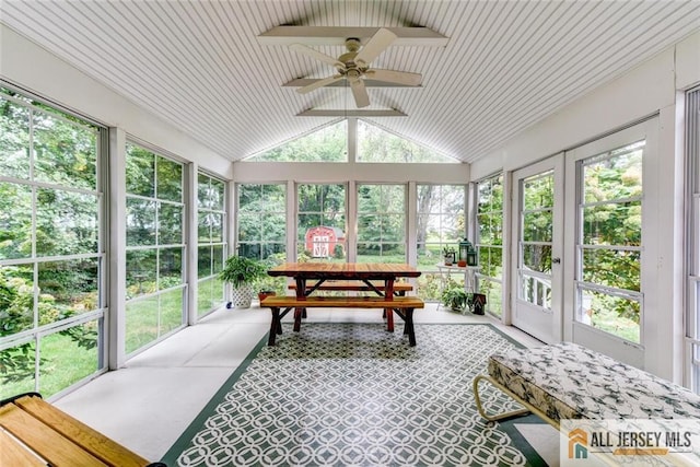 sunroom / solarium with ceiling fan and vaulted ceiling