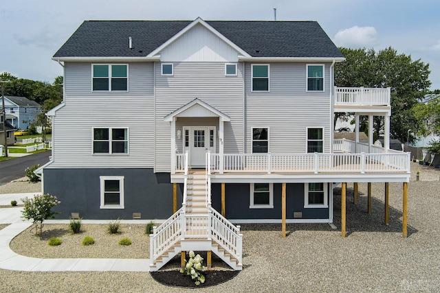 view of front of house with a wooden deck, stairs, and a shingled roof