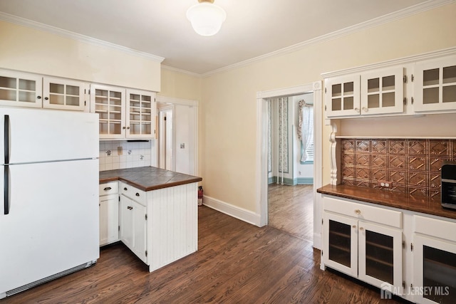 22 Booream Ave, Milltown, NJ 08850 - kitchen featuring white cabinets, freestanding refrigerator, decorative backsplash, dark wood-type flooring, and ornamental molding