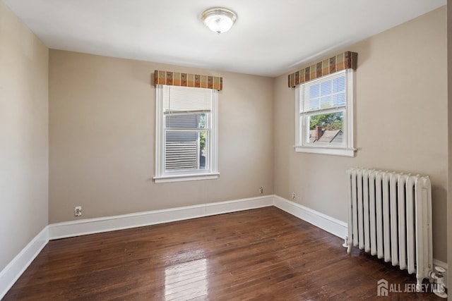 22 Booream Ave, Milltown, NJ 08850 - spare room featuring wood-type flooring, baseboards, and radiator