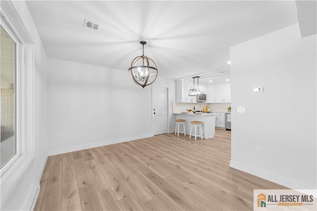 737 Prospect Rd Unit 737A, Monroe, NJ 08831 - unfurnished dining area featuring a chandelier, light wood finished floors, recessed lighting, and baseboards
