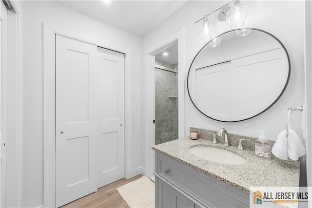 737 Prospect Rd Unit 737A, Monroe, NJ 08831 - bathroom featuring vanity, wood finished floors, and a shower with door