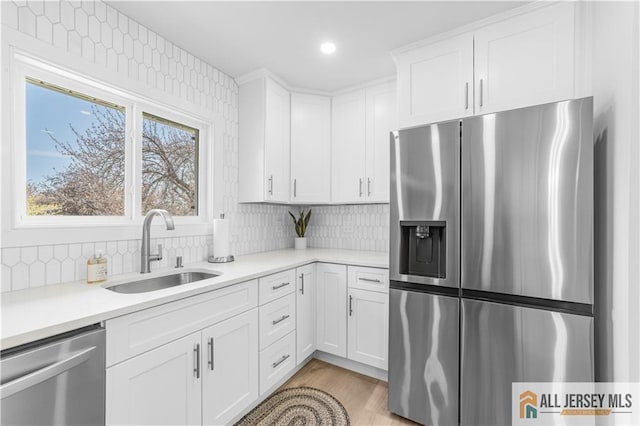737 Prospect Rd Unit 737A, Monroe, NJ 08831 - kitchen featuring stainless steel appliances, a sink, light countertops, white cabinetry, and tasteful backsplash