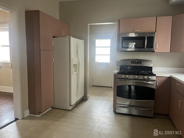 145 Cooper Ave, Iselin, NJ 08830 - kitchen featuring stainless steel appliances, light countertops, light floors, and baseboards