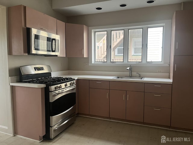 145 Cooper Ave, Iselin, NJ 08830 - kitchen with appliances with stainless steel finishes, a sink, light countertops, and light flooring