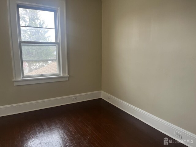 145 Cooper Ave, Iselin, NJ 08830 - spare room featuring dark wood-style flooring, baseboards, and healthy amount of natural light