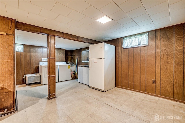 6 N Minnisink Ave, Sayreville, NJ 08859 - below grade area with freestanding refrigerator, wood walls, washer and clothes dryer, light floors, and plenty of natural light