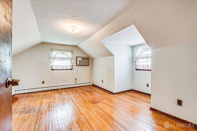 6 N Minnisink Ave, Sayreville, NJ 08859 - bonus room featuring a baseboard radiator, hardwood / wood-style flooring, vaulted ceiling, baseboards, and a wall mounted air conditioner