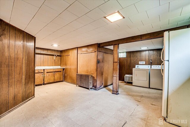 6 N Minnisink Ave, Sayreville, NJ 08859 - basement with washer and clothes dryer, wooden walls, freestanding refrigerator, and light flooring