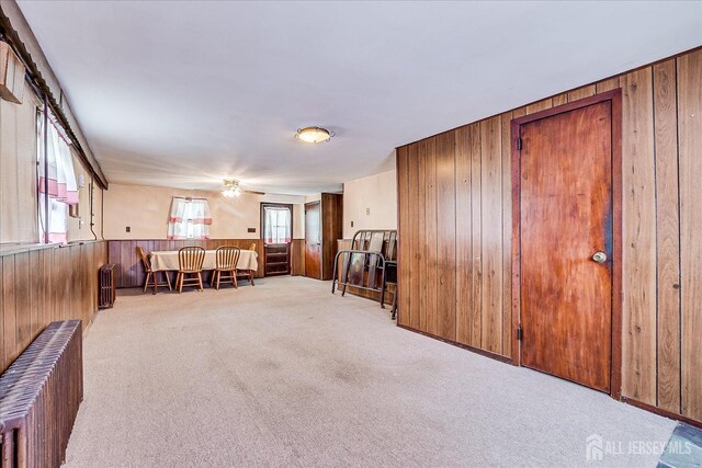 6 N Minnisink Ave, Sayreville, NJ 08859 - sitting room featuring wooden walls, carpet, ceiling fan, and radiator