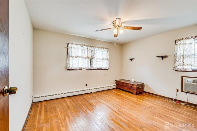 6 N Minnisink Ave, Sayreville, NJ 08859 - unfurnished room featuring a baseboard heating unit, ceiling fan, wood-type flooring, a wall mounted air conditioner, and baseboards