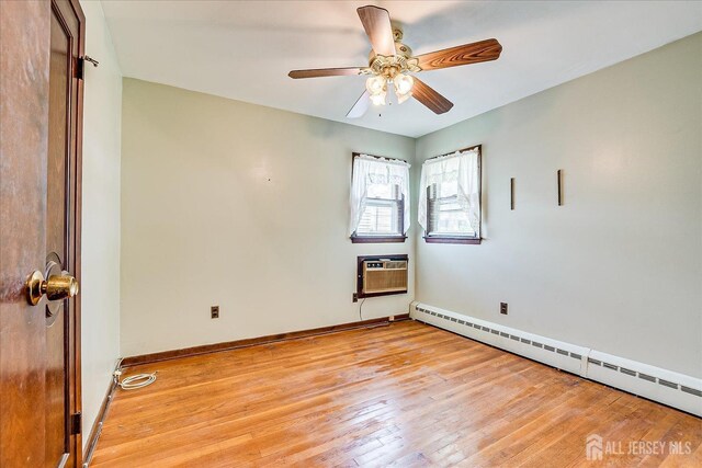 6 N Minnisink Ave, Sayreville, NJ 08859 - spare room featuring a wall mounted AC, a baseboard radiator, light wood finished floors, and baseboards