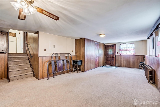6 N Minnisink Ave, Sayreville, NJ 08859 - living room with wood walls, radiator, carpet flooring, ceiling fan, and a wainscoted wall