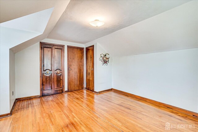 6 N Minnisink Ave, Sayreville, NJ 08859 - additional living space featuring lofted ceiling, light wood finished floors, and baseboards