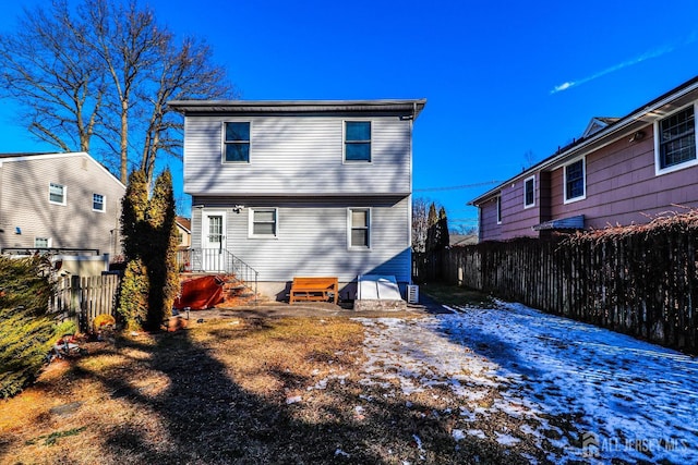 rear view of property with fence