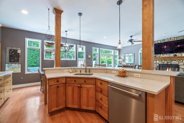 28 Sugarbush Rd, Howell, NJ 07731 - kitchen with stainless steel dishwasher, open floor plan, light wood-type flooring, a ceiling fan, and a stone fireplace