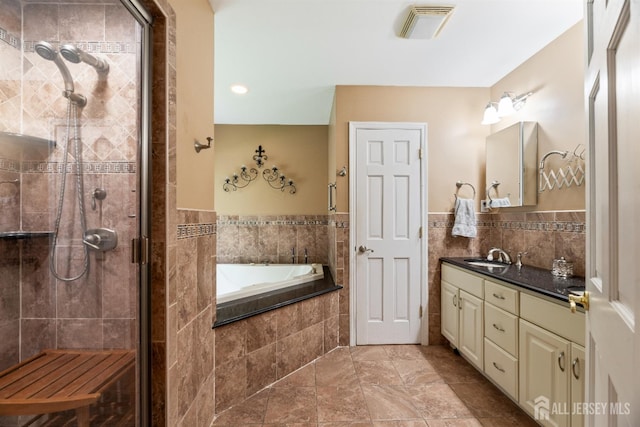 28 Sugarbush Rd, Howell, NJ 07731 - full bath with vanity, a bath, a shower stall, tile walls, and wainscoting