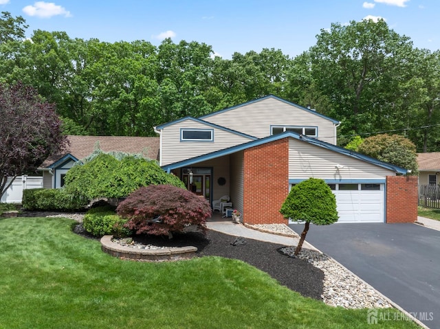 28 Sugarbush Rd, Howell, NJ 07731 - view of front of house featuring asphalt driveway, an attached garage, and brick siding