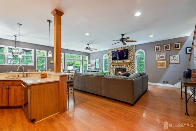 28 Sugarbush Rd, Howell, NJ 07731 - living room with light wood-type flooring, a stone fireplace, recessed lighting, and ceiling fan