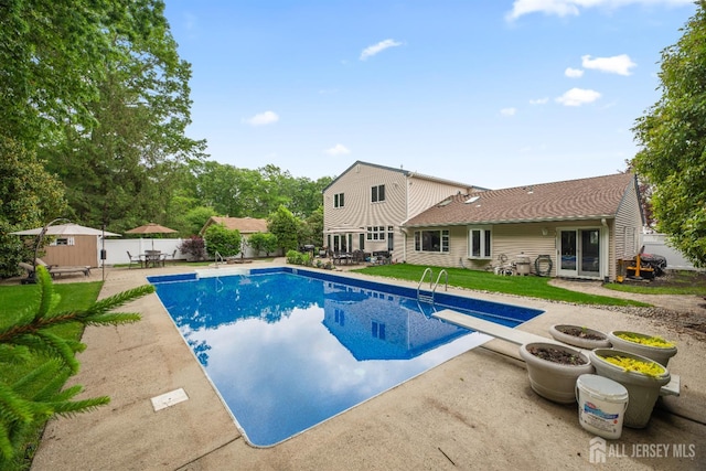 28 Sugarbush Rd, Howell, NJ 07731 - view of pool with a diving board, a patio area, a shed, and a fenced backyard