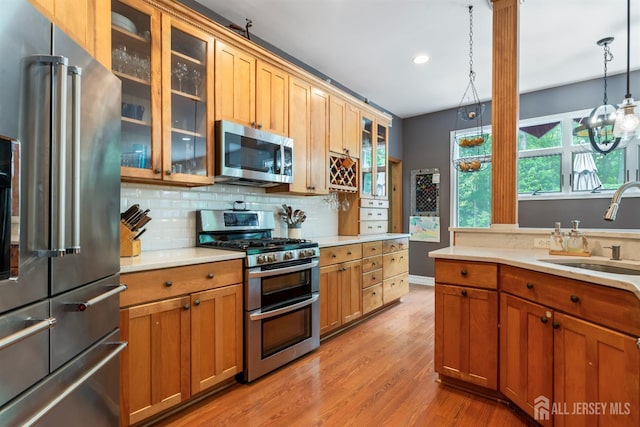 28 Sugarbush Rd, Howell, NJ 07731 - kitchen featuring appliances with stainless steel finishes, light countertops, light wood-style flooring, backsplash, and recessed lighting