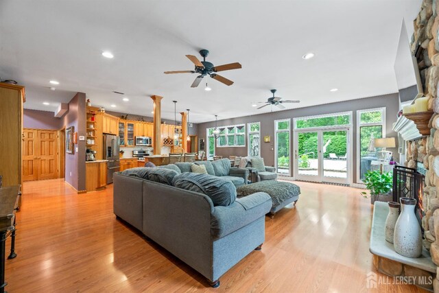 28 Sugarbush Rd, Howell, NJ 07731 - living area featuring light wood-type flooring, a stone fireplace, recessed lighting, and a ceiling fan
