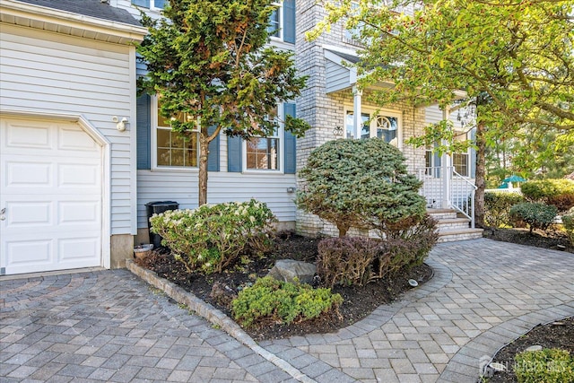 12 Carriage Dr, Piscataway, NJ 08854 - doorway to property with a garage and decorative driveway