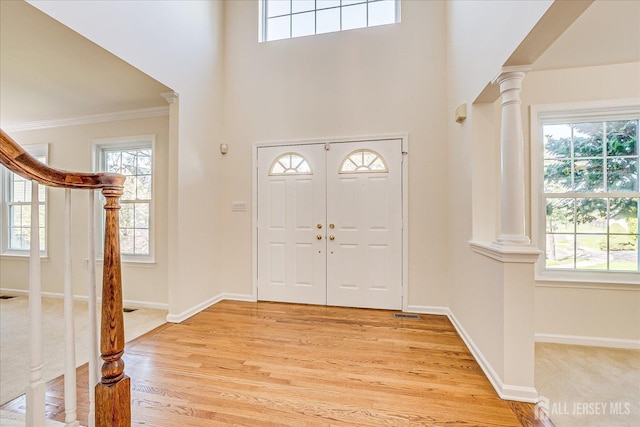 12 Carriage Dr, Piscataway, NJ 08854 - foyer with ornate columns, light wood-style floors, stairs, crown molding, and baseboards