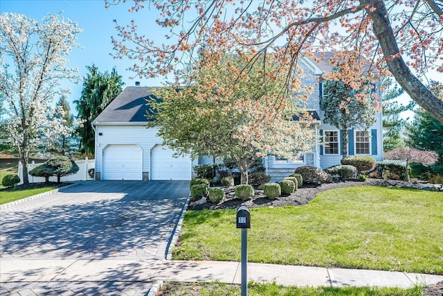 12 Carriage Dr, Piscataway, NJ 08854 - obstructed view of property with driveway, a front yard, and a garage