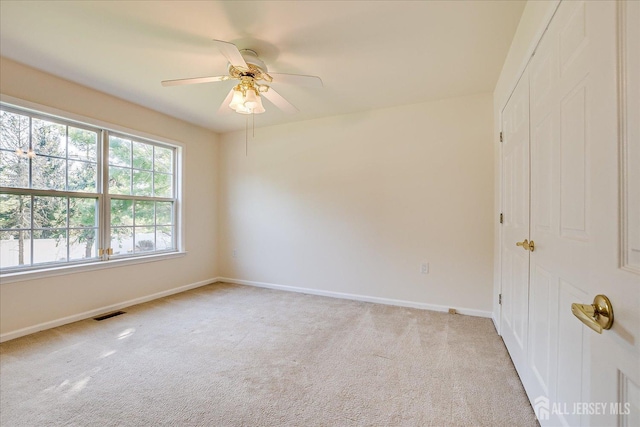 12 Carriage Dr, Piscataway, NJ 08854 - spare room featuring light carpet, baseboards, and a ceiling fan