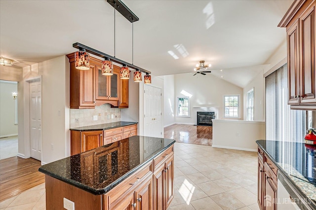 12 Carriage Dr, Piscataway, NJ 08854 - kitchen with brown cabinets, a glass covered fireplace, light tile patterned flooring, baseboards, and backsplash