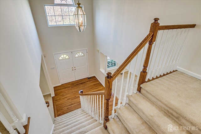 12 Carriage Dr, Piscataway, NJ 08854 - entrance foyer featuring healthy amount of natural light, stairs, baseboards, a high ceiling, and wood finished floors