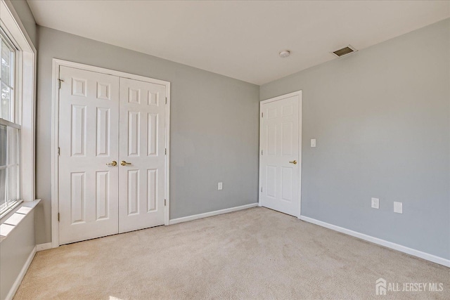 12 Carriage Dr, Piscataway, NJ 08854 - unfurnished bedroom with carpet floors, baseboards, and a closet